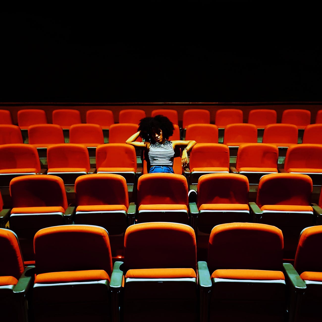 woman sitting inside a theater